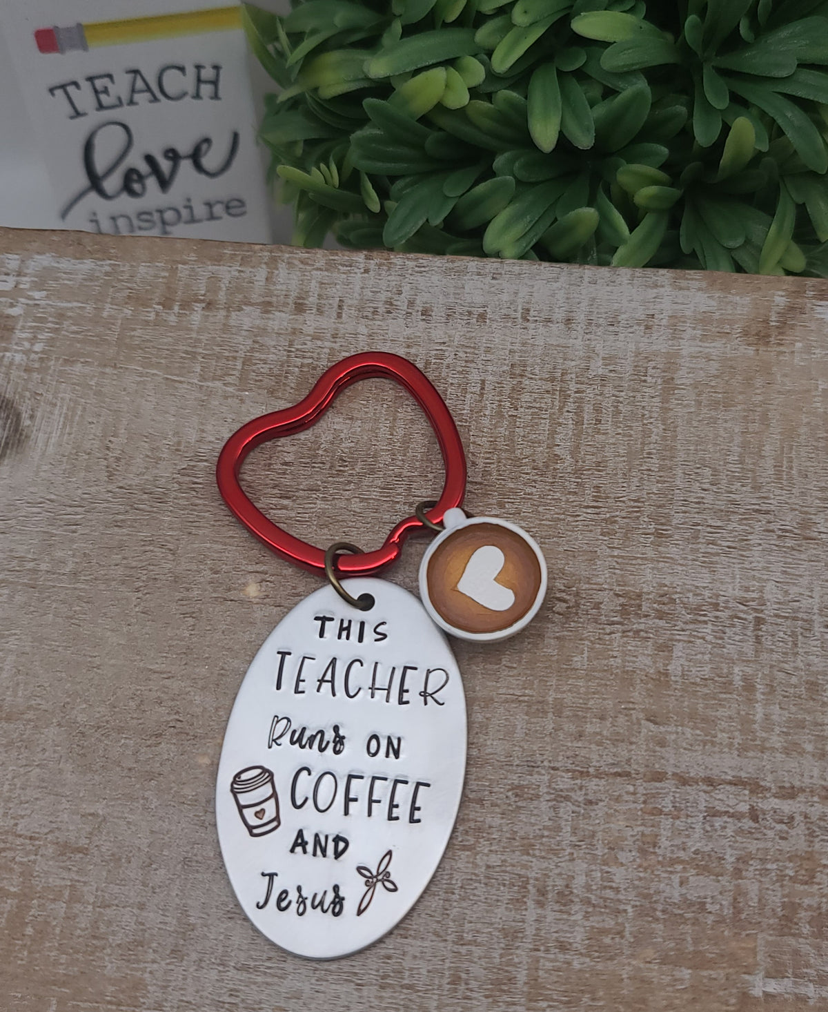 This keychain with "This Teacher Runs on Coffee and Jesus" stamped on aluminum oval, plus a red apple keyring and coffee cup charm, expresses the day-to-day of teachers!