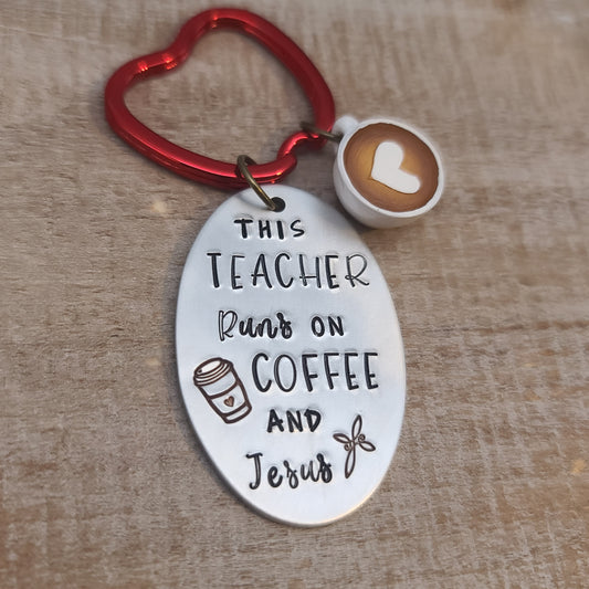 This keychain with "This Teacher Runs on Coffee and Jesus" stamped on aluminum oval, plus a red apple keyring and coffee cup charm, expresses the day-to-day of teachers!